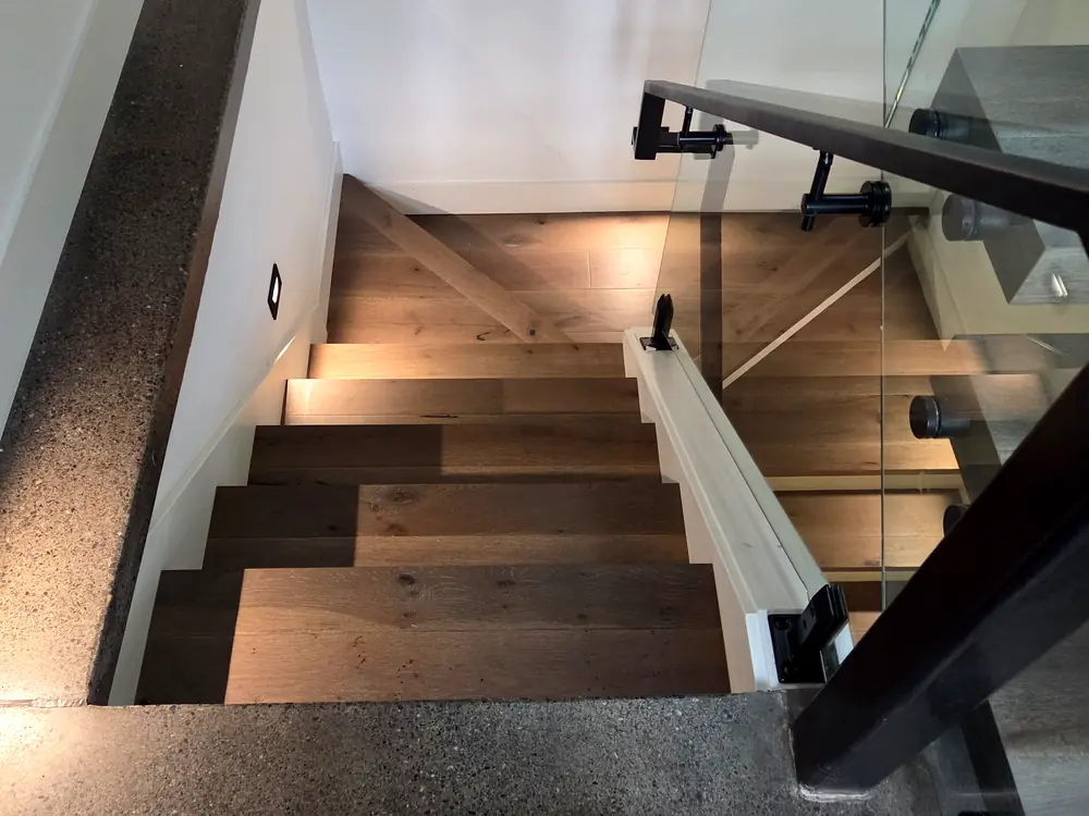 Stairs running beside a glass rail